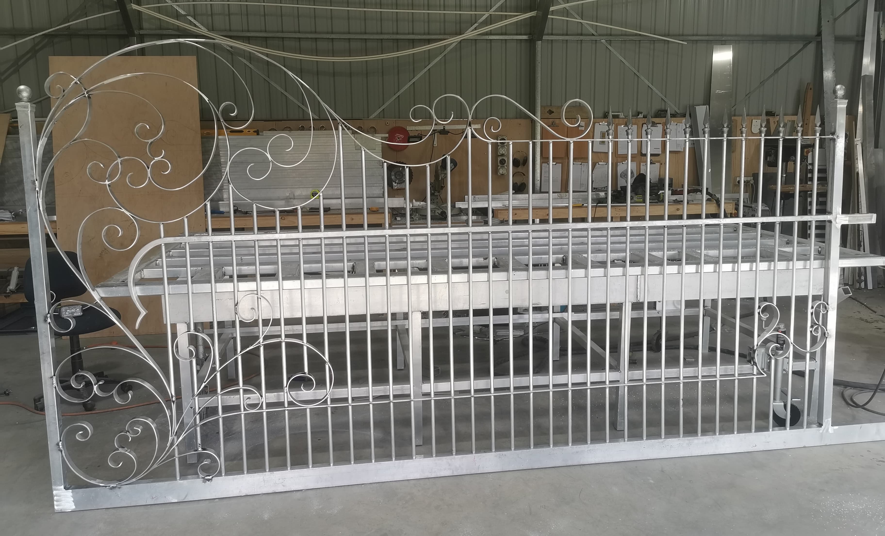 White decorative gate panel in workshop