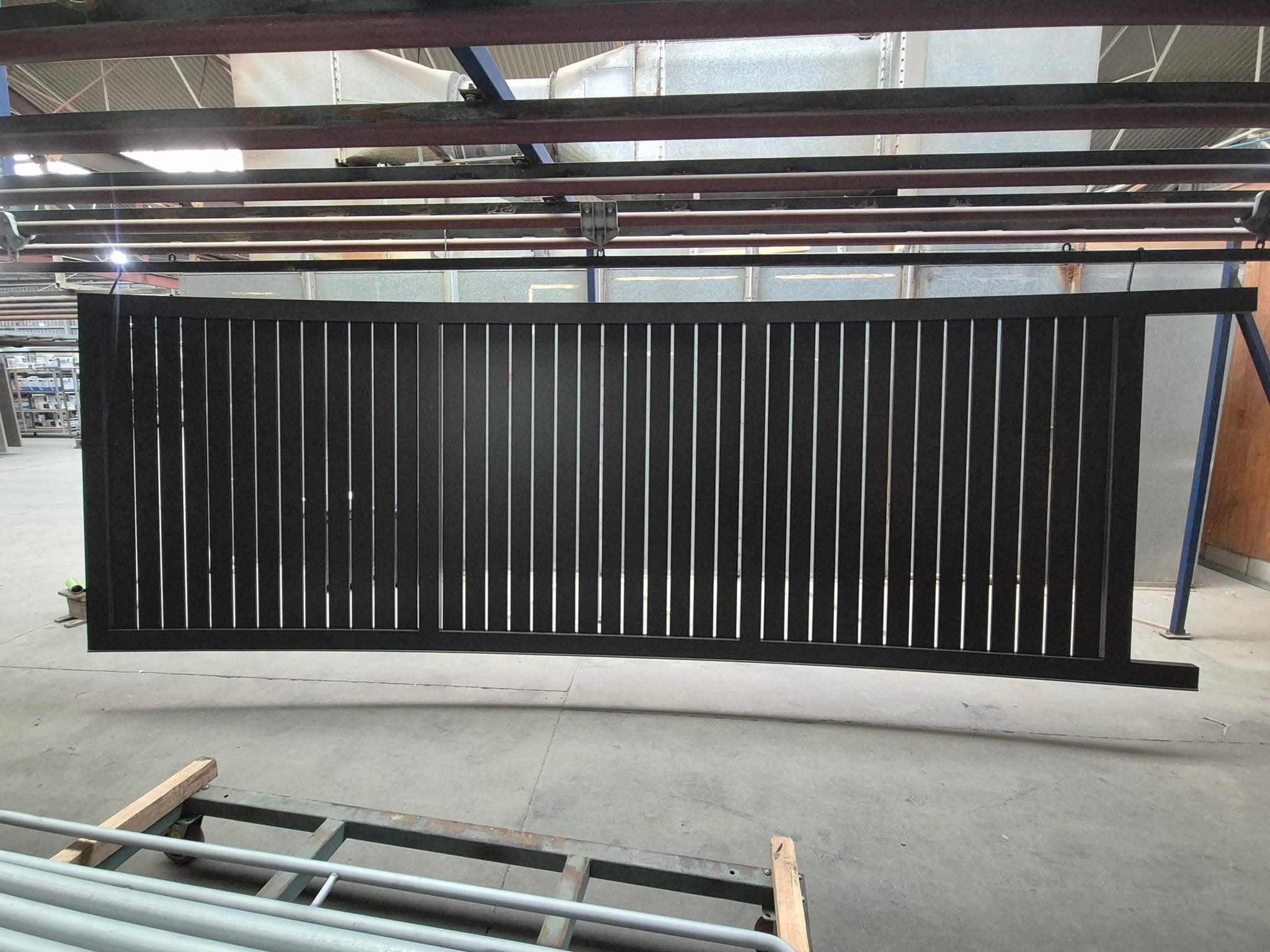 Black horizontal slat driveway gate
