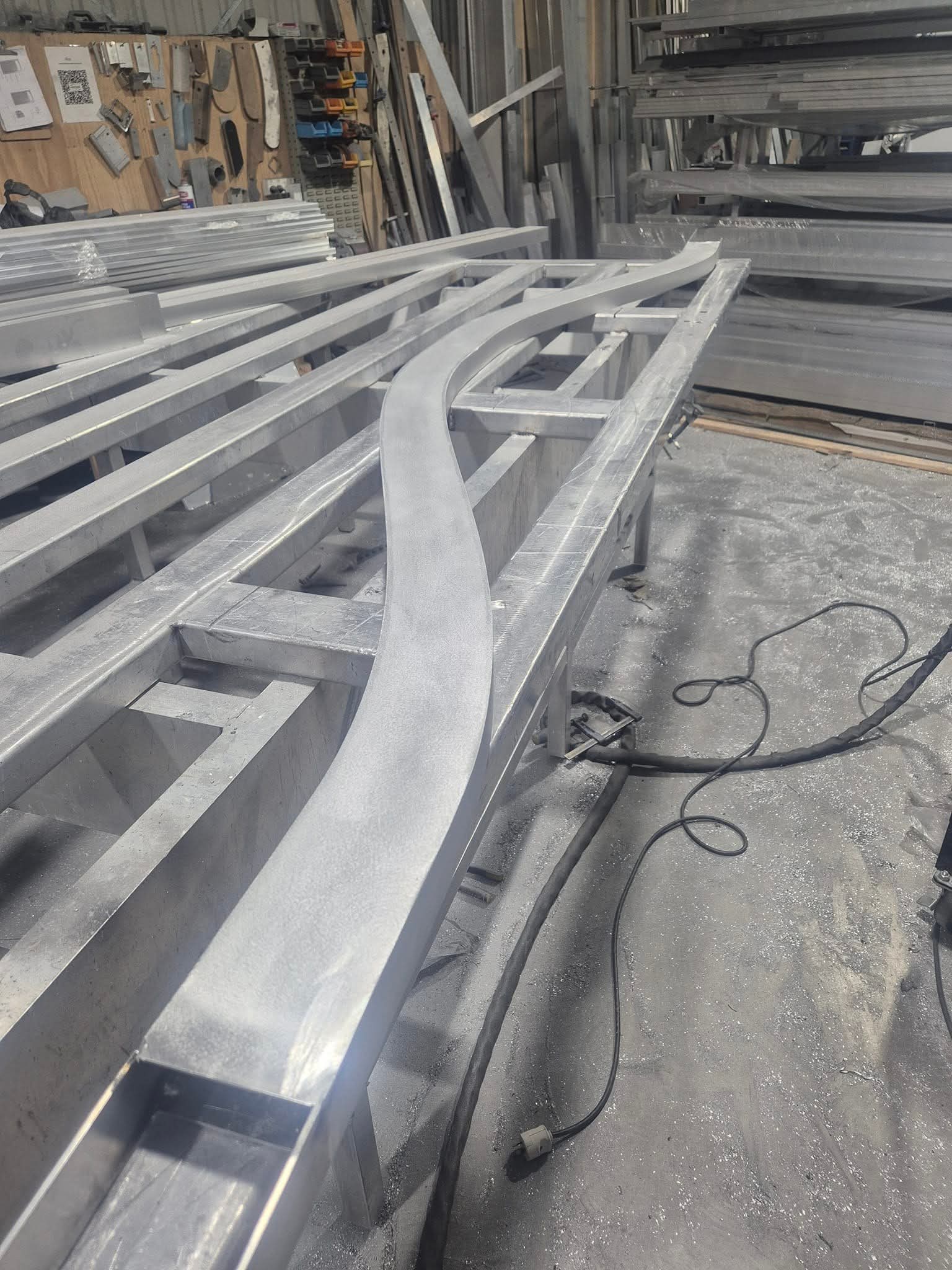 Curved aluminium framework taking shape in the workshop