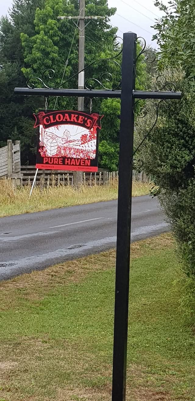 Custom hand-forged bracket holding a hanging property sign