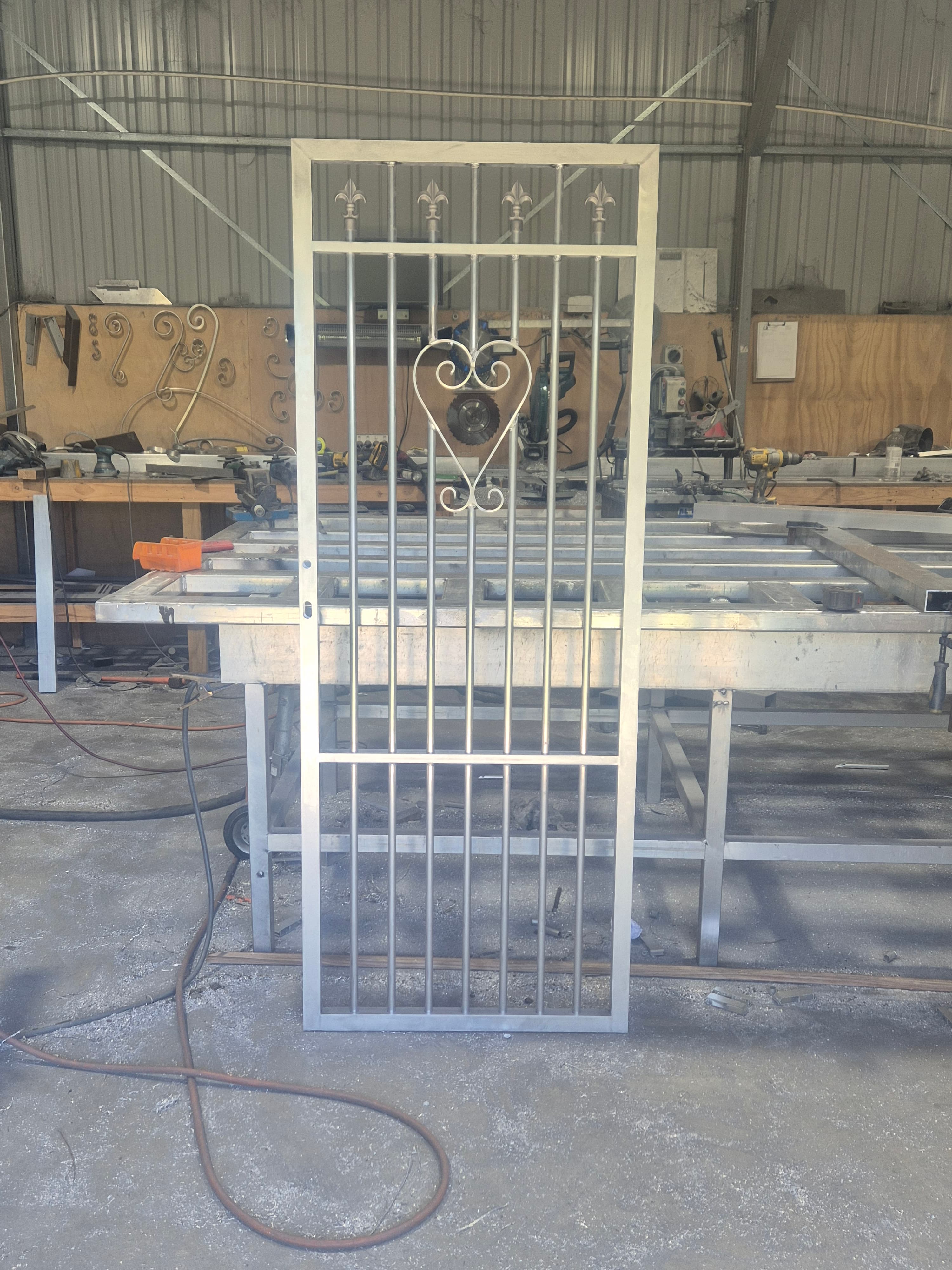 Close-up of hand-forged leaf scrollwork on a gate